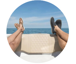Two people on a boat with their feet kicked up.